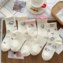 Set of five white cotton mid-tube socks featuring cute cartoon patterns and frilled cuffs