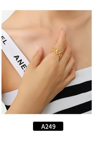 Close-up of a chunky 18K gold-plated rectangular chain ring on a model's finger