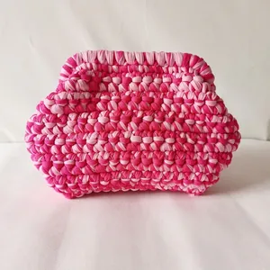 Detailed macro view of the two-tone pink handmade woven cotton fabric clutch bag texture