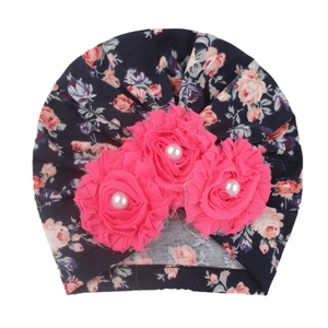 Floral baby beanie with sunflower pearls on dark blue printed cotton fabric for infants