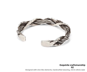 Detailed close-up of handmade woven Thai silver bracelet with retro vine rope texture