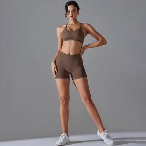 Detail of seamless knit yoga set featuring a brown sports bra and high-waisted shorts