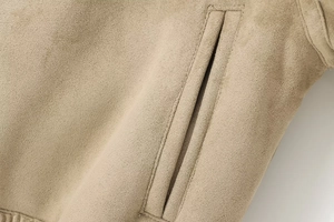 Close-up detail of khaki reversible jacket pocket with premium stitching and suede fabric