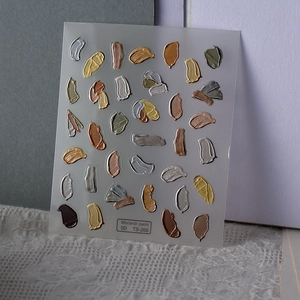 Macro shot of 5D embossed Morandi oil painting nail stickers with 3D metallic texture