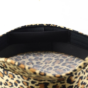 Detail of leopard print hat lining with black elastic adjustment band and inner stitching