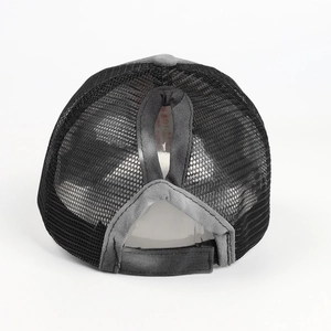 Detail of high-breathability black mesh ponytail hole and adjustable velcro strap on cap