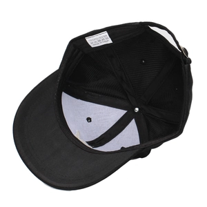 Internal structure of black baseball cap showing 100% polyester fabric and seams