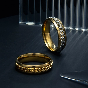 Detailed close-up of rotating chain rings in gold and silver stainless steel finish