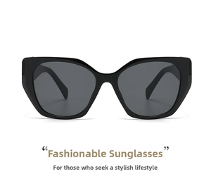 Detail of black cat-eye sunglasses featuring shiny plastic frames and dark grey lenses