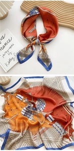 Close-up of silk neckerchief with orange and blue geometric patterns and fine stitched edges