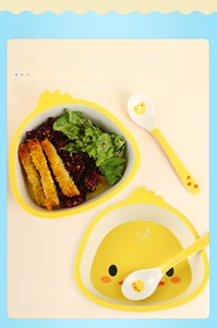 Close-up of yellow duck kids plate with divided sections for baby food and snacks