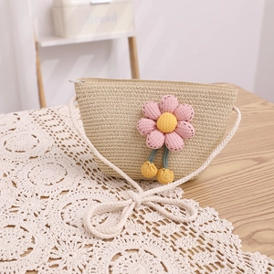 Détail du sac bandoulière en paille avec fleur rose et bandoulière en corde de coton