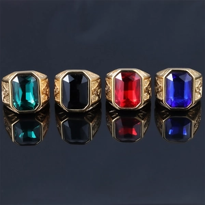 Row of Masonic rings with red blue green and black gemstones in gold engraved settings