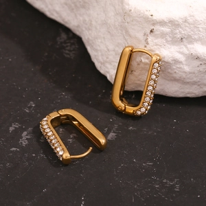 Detail of 18K gold plated U-shaped earrings featuring micro-inlaid cubic zirconia crystals