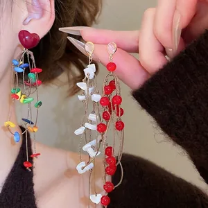 Handmade beaded long tassel earrings with heart-shaped hooks and shell charms