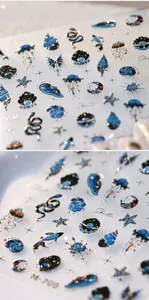 Macro view of ocean-themed embossed nail stickers featuring blue shells and jellyfish