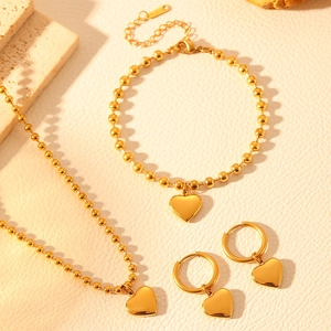 Golden beaded stainless steel jewelry set with heart pendants including necklace and bracelet