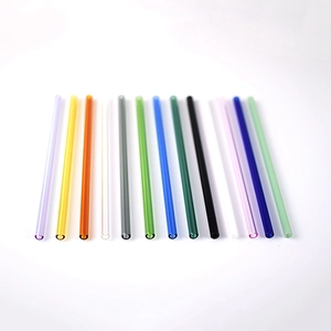 Detailed arrangement of thirteen colorful heat-resistant glass straws on white background