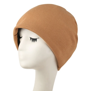 Detailed knit texture of a caramel winter beanie on a display head showing a snug fit