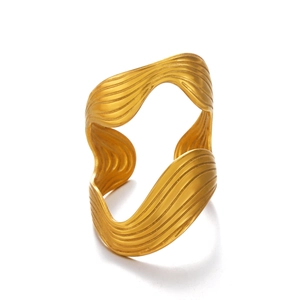 Modern irregular wave gold open bangle with sculptural metallic texture on white background