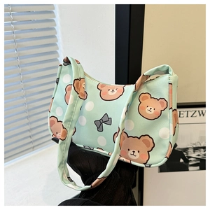 Detail of light green polka dot fabric with cute brown teddy bear print and grey bow
