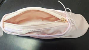 Pink satin ballet slipper pencil case with a gold zipper and inner lining detail