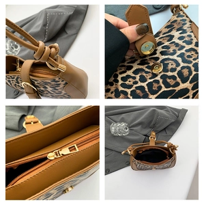 Detail of leopard print handbag showing magnetic snap, zipper, and knotted shoulder strap
