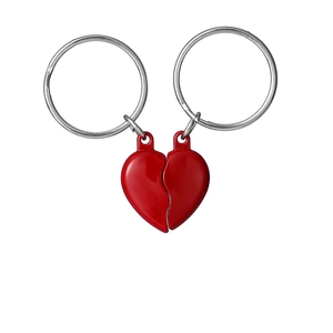 Detail of red magnetic heart keychains for couples with polished metal finish