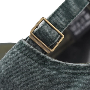 Macro view of adjustable bronze metal buckle and washed vintage cotton fabric on baseball cap