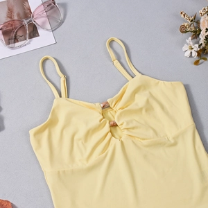 Detailed view of yellow camisole with pleated bust and decorative stone texture ring buckle