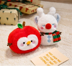 Close-up of cute plush Santa apple and reindeer snowman dolls with soft texture