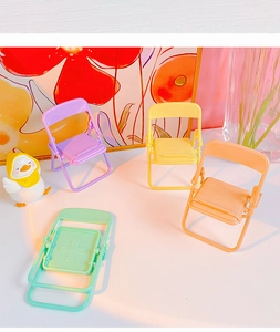 Set of four colorful mini folding chair phone holders in purple yellow orange and green