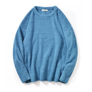 Detail of blue crewneck knit sweater showing soft chenille texture and thick fabric