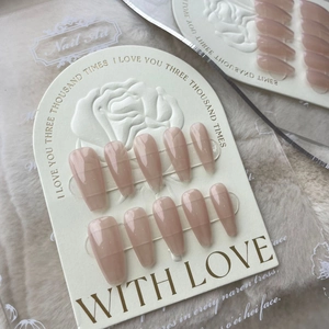 Handmade long coffin press-on nails in nude with stripe details on rose embossed card