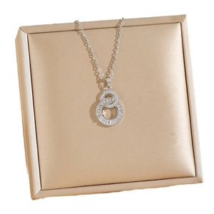 Elegant silver interlocking double ring necklace with cubic zirconia on champagne velvet box