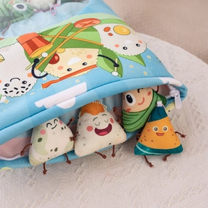Detail of plush storage bag with cute cartoon dumpling toys peeking out of the opening