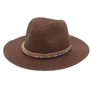Detail of dark brown straw fedora featuring bohemian beads and braided rope band