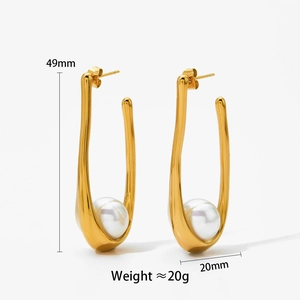 Detail view of gold U-shaped earrings with pearls showing size 49mm by 20mm specs