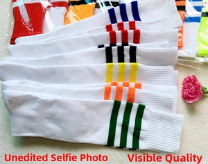 Detail of colorful striped knee-high football socks with rib-knit elastic cuffs