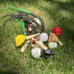 Detailed close-up of mini baseball keychains with wooden bat and colorful leather gloves