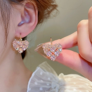 Elegant gold earrings featuring pink heart-shaped charms pavé-set with sparkling zircons