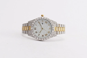 Detail shot of luxury men's watch with iced-out crystals and two-tone gold silver band