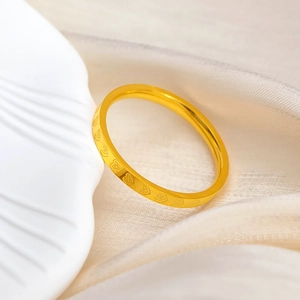 Elegant 18k gold plated stainless steel heart pattern ring on silk background