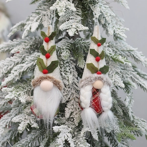 Pair of festive Christmas tree gnomes with knitted hats and plaid outfits hanging on branches