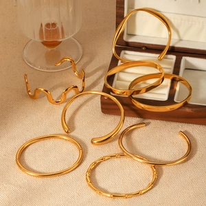Detailed close-up of 18K gold plated stainless steel bangles with textured patterns