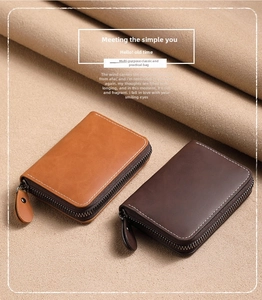 Detail view of brown leather zip card holders with textured finish and white stitching