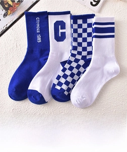 Set of four cotton crew socks in blue and white featuring checkerboard and stripe patterns