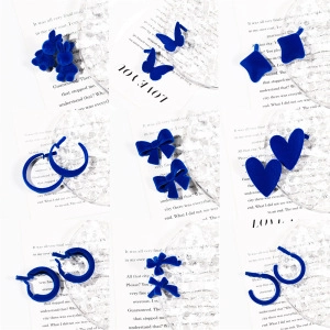 Detailed grid of flocking blue earrings in heart, rabbit, and geometric shapes