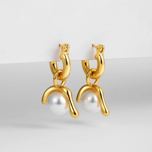 Detail view of gold vintage earrings with detachable natural pearls in high-end finish
