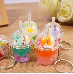 Detailed close-up of cute bear ice cream cup keychains on a wooden surface